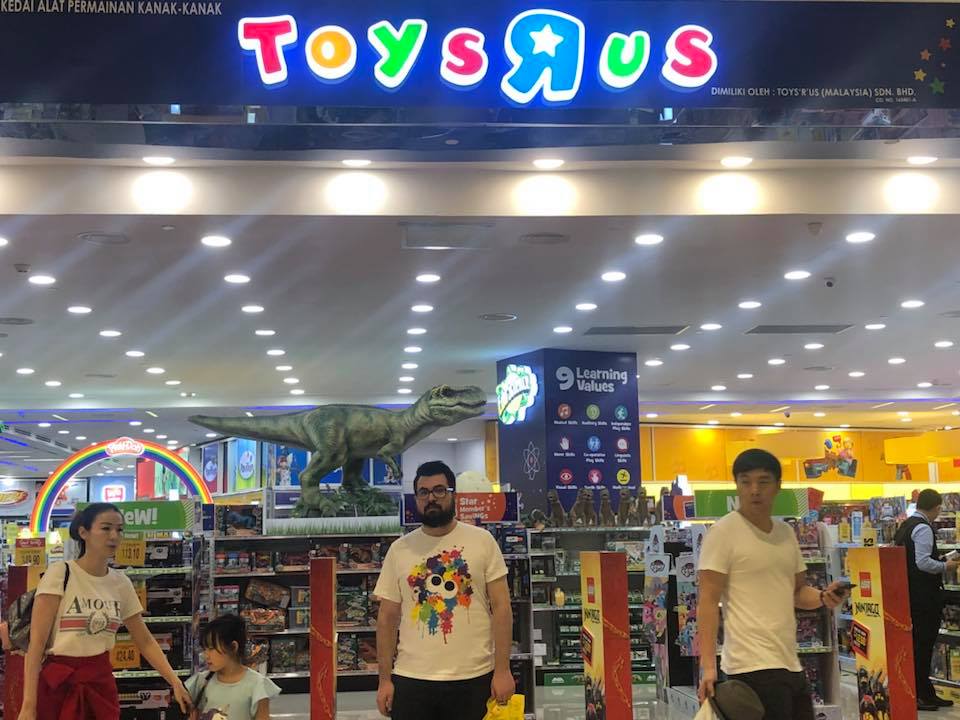 Keith in front of a Toys R Us in Malaysia 